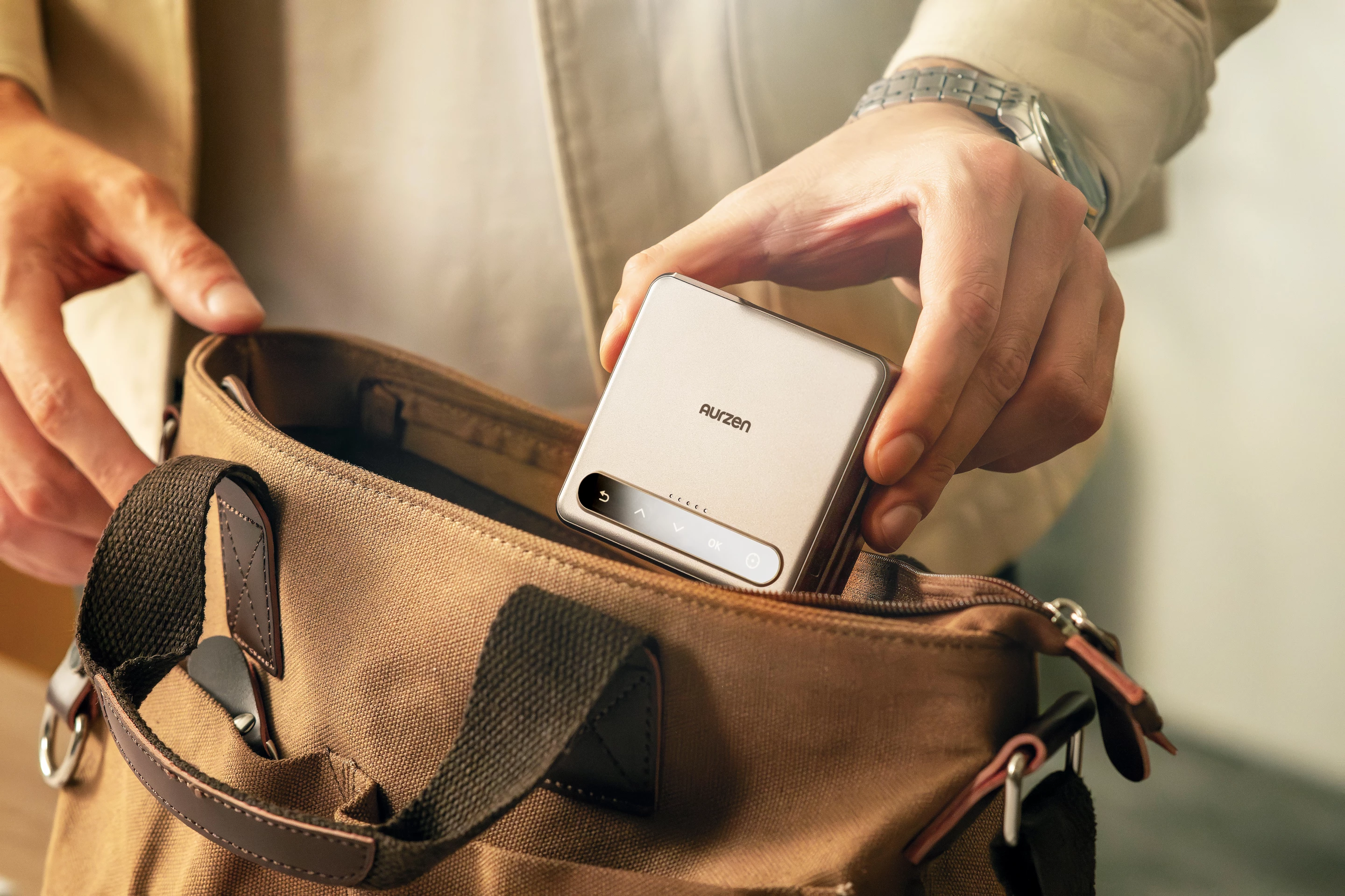 .Portable mini projector stands on its own with tri-fold hinge