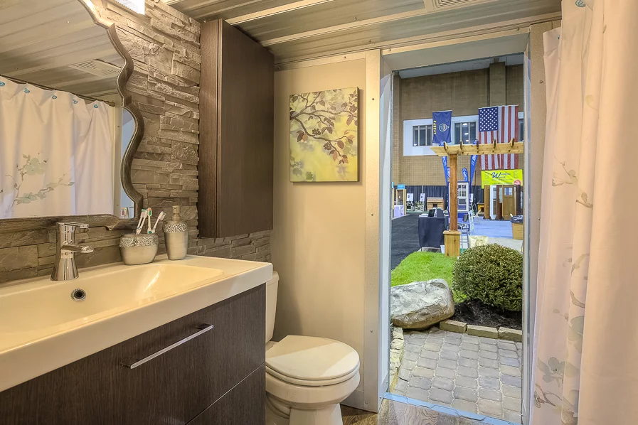 The bathroom includes a toilet, sink with vanity unit, and shower/bath