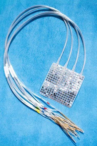 An ECoG array features a pad of electrodes that is surgically placed on the surface of the brain