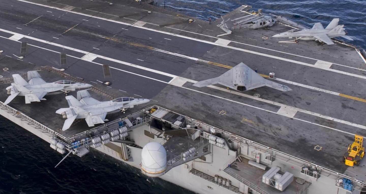 The relative size of the X-47B to manned fighters (Photo: U.S. Navy MC3 Kristina Young)