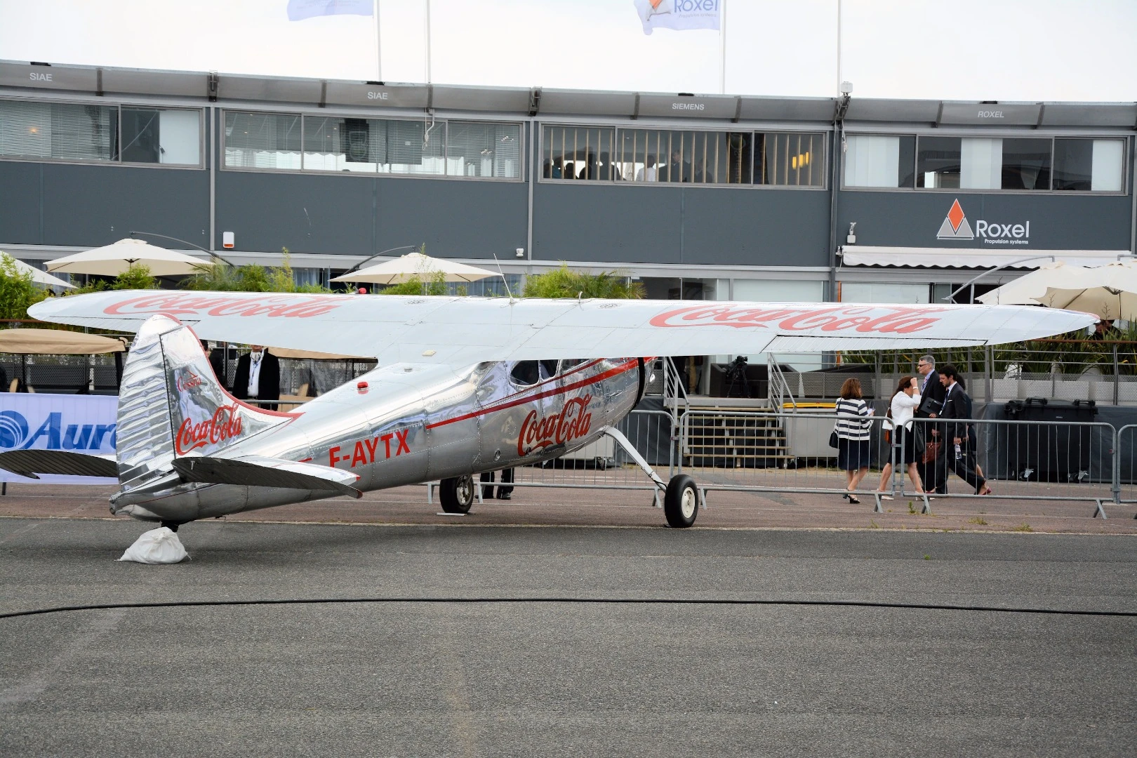 A Cessna sporting brand colors for a certain popular carbonated soft drink