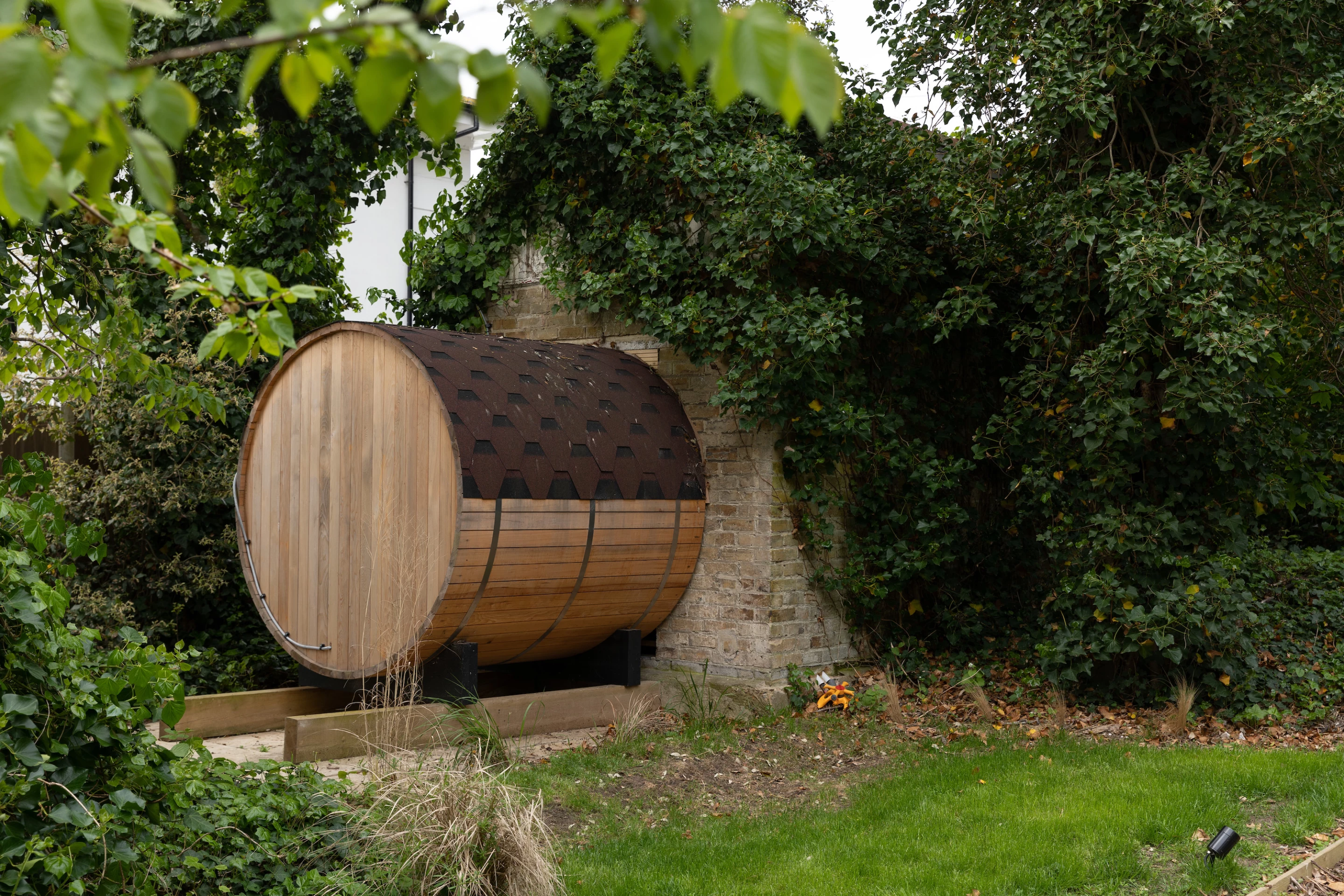 Woven's garden includes a small barrel-shaped sauna area