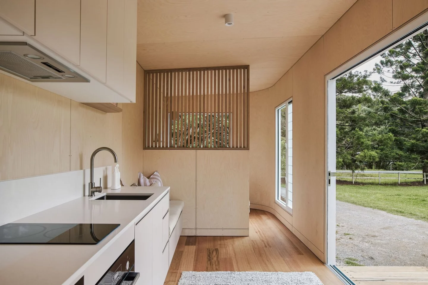 The Harper tiny house's bedroom is separated from the rest of the house by a dividing wall for privacy