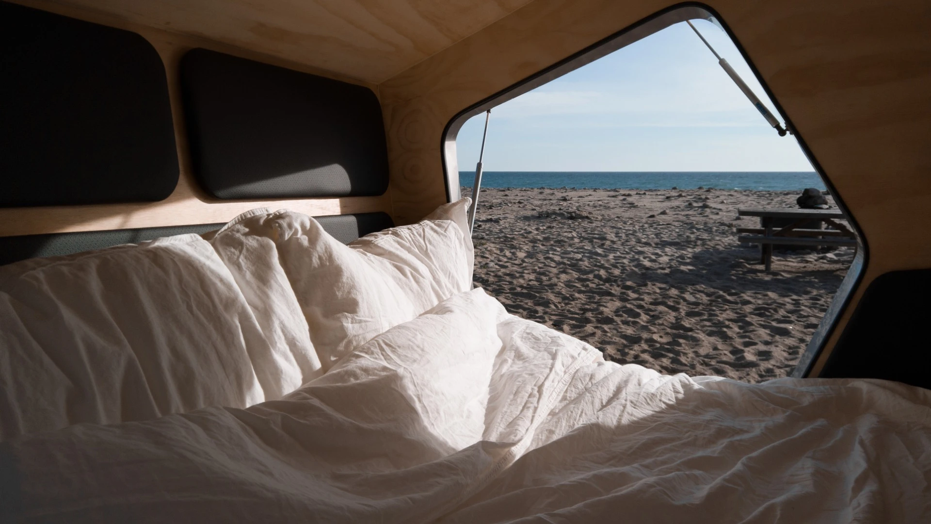 The interior has polyurethaned plywood walls and black leather trim