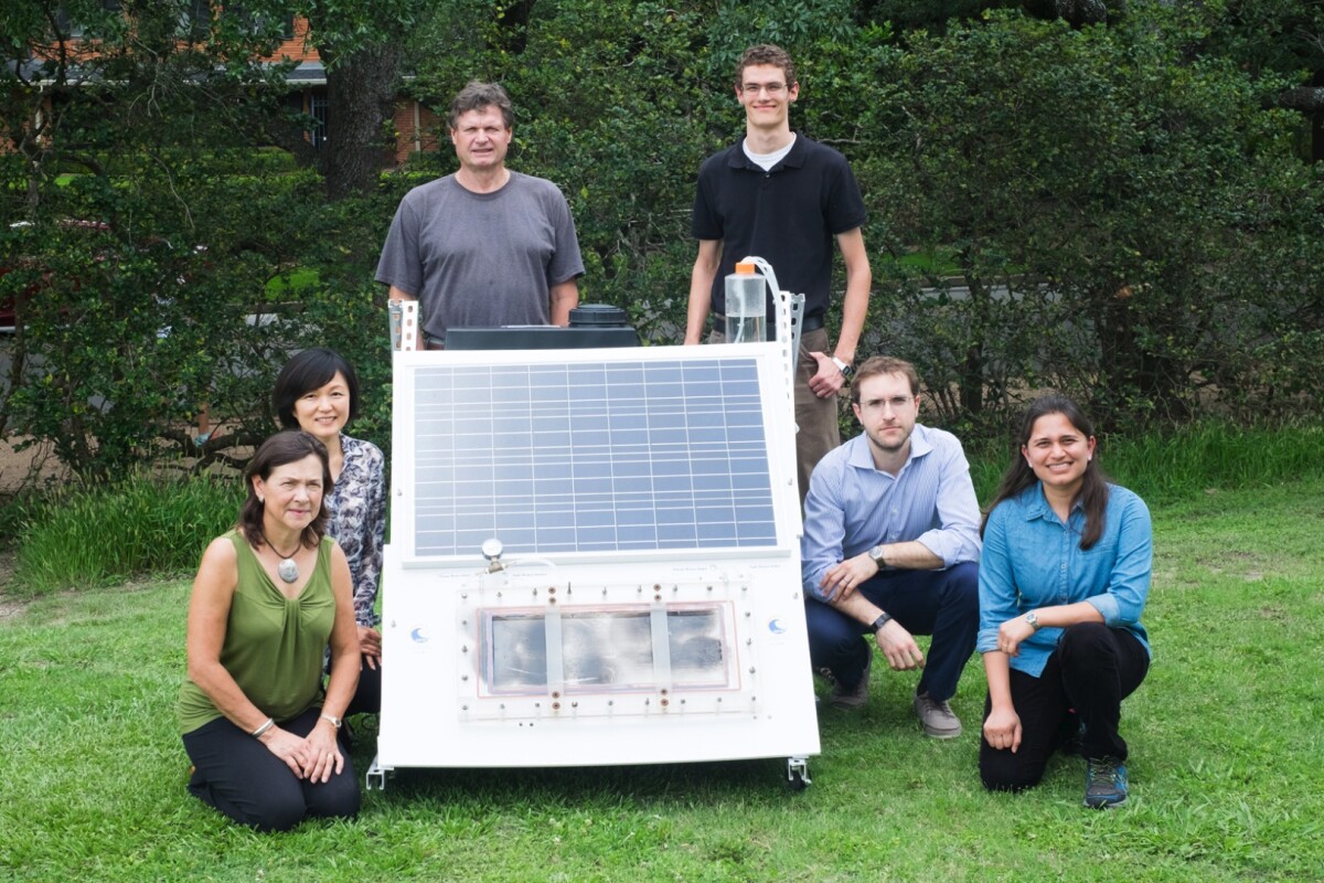The researchers with a scaled-up version of their solar membrane distillation system
