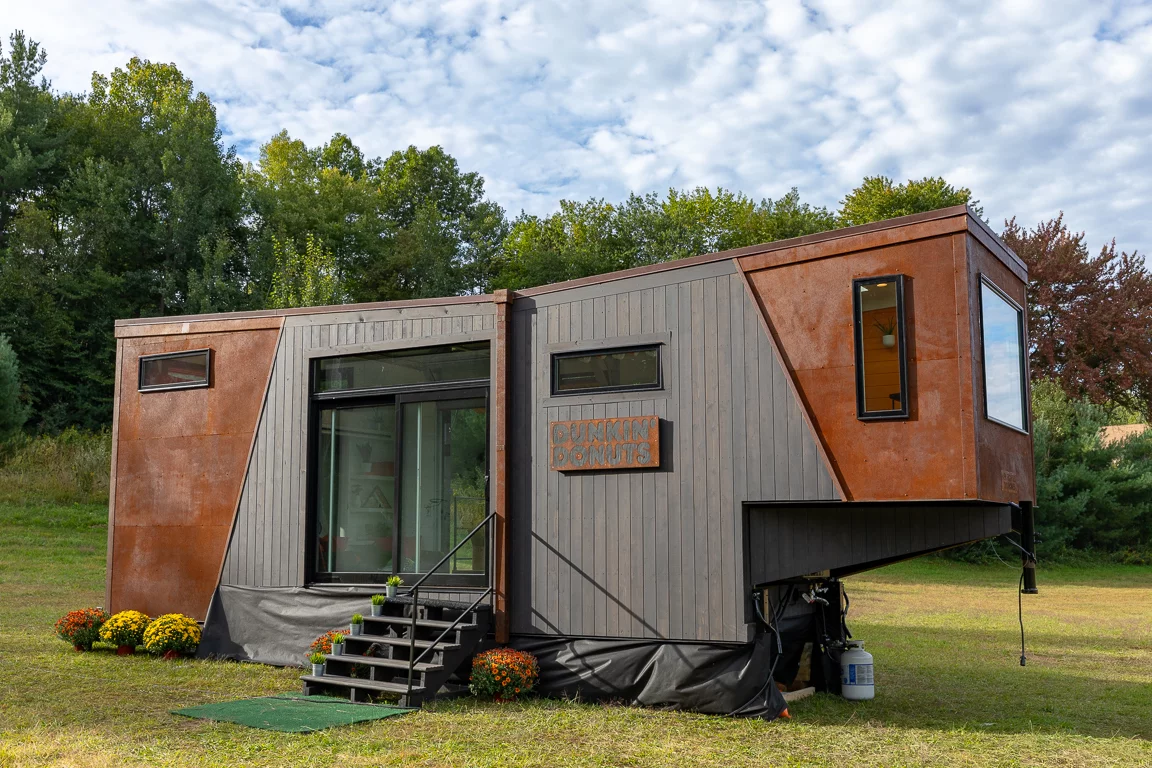 The Home That Runs on Dunkin' appears to be based on New Frontier Tiny Homes' Escher model