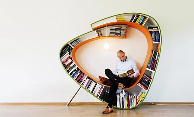 The Bookworm is a chair that surrounds the reader with their library, literally