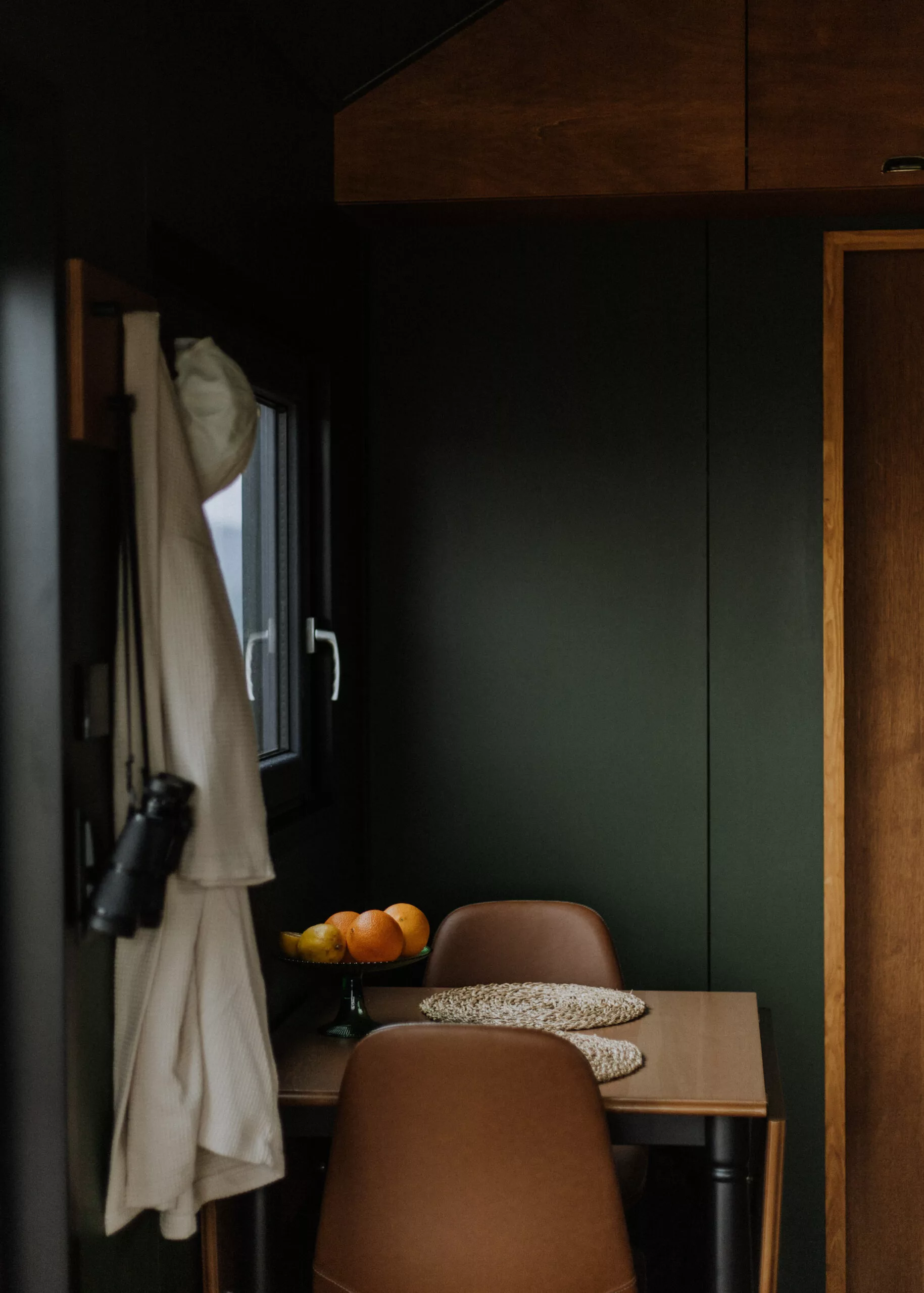 The Tiny Amsterdam's kitchen area includes a small dining table for two that could double as a home working area