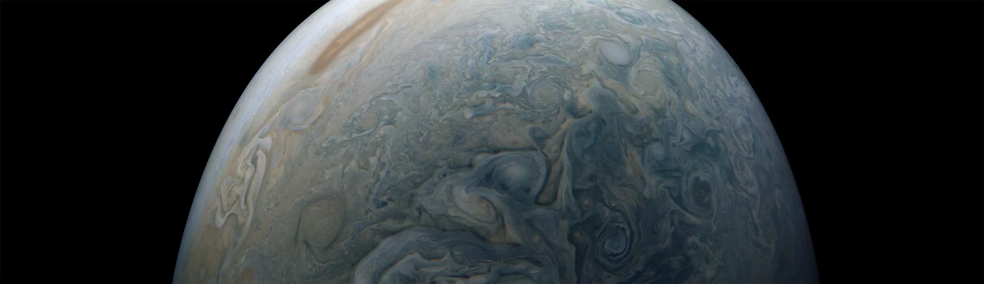 Clouds in a Jovian jet stream, called Jet N5, swirl in the center of this color-enhanced image