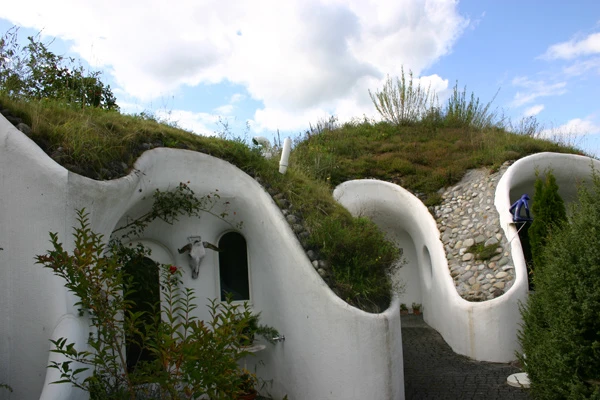 The Earth House Estate Lättenstrasse in Switzerland consists of several Hobbit Hole-style dwellings located around a wet courtyard