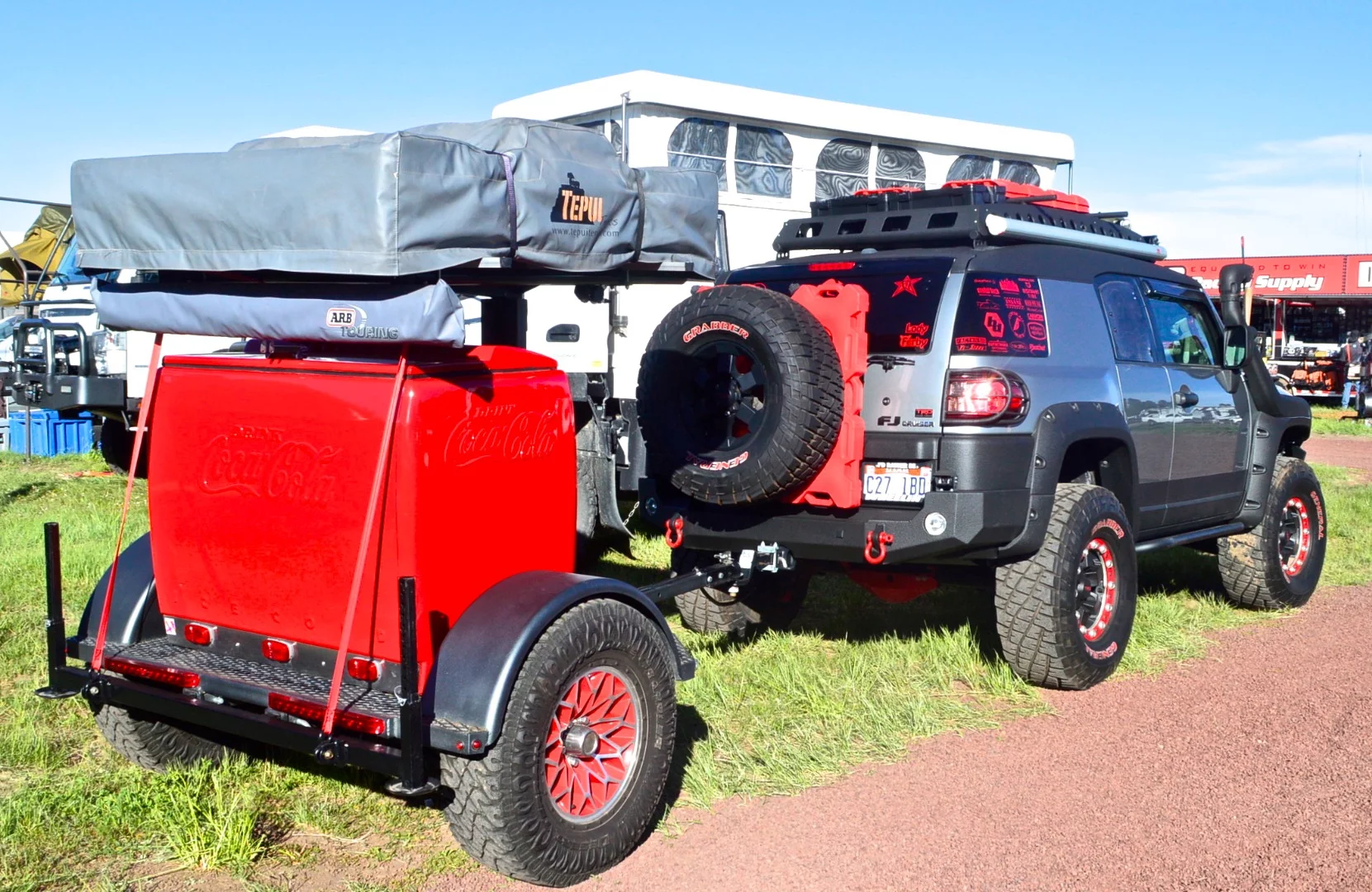 A different kind of camping trailer, complete with classic-looking Coke fridge