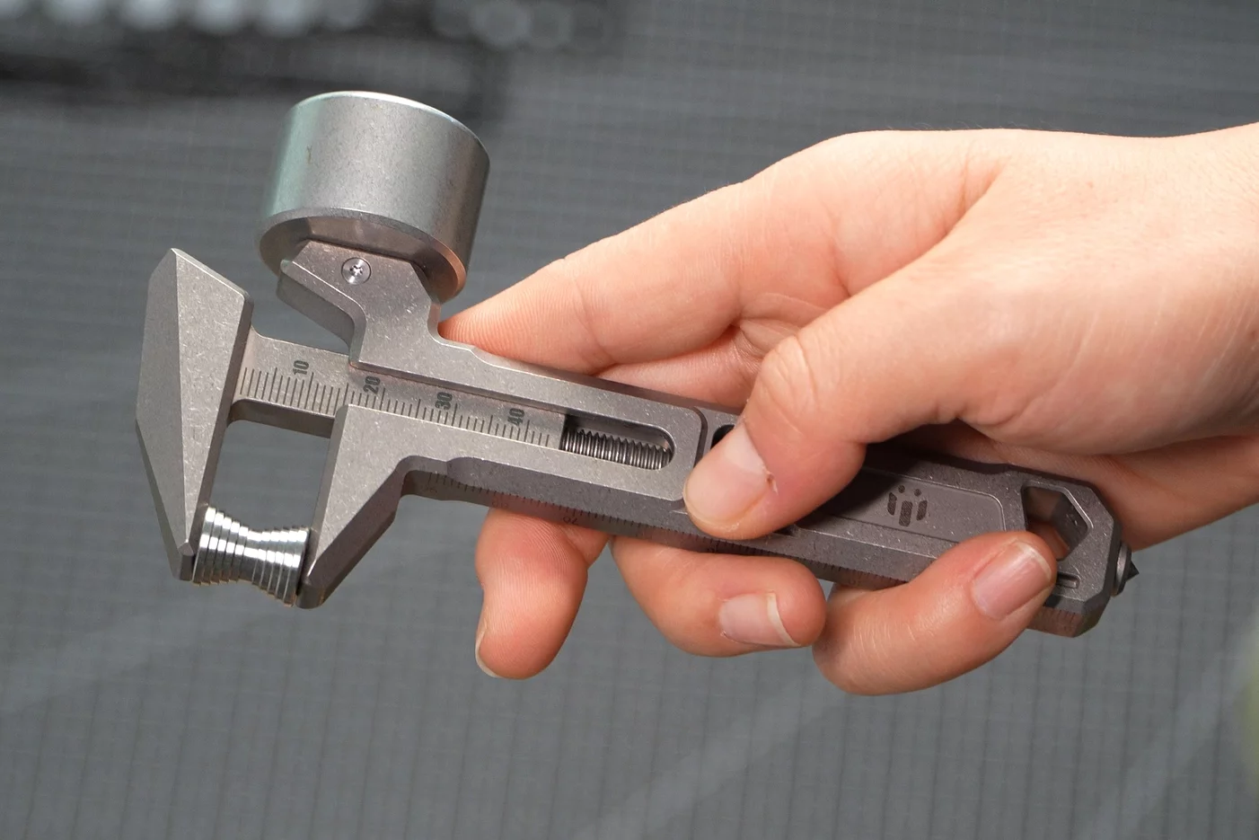 The caliper-style precision scale in use