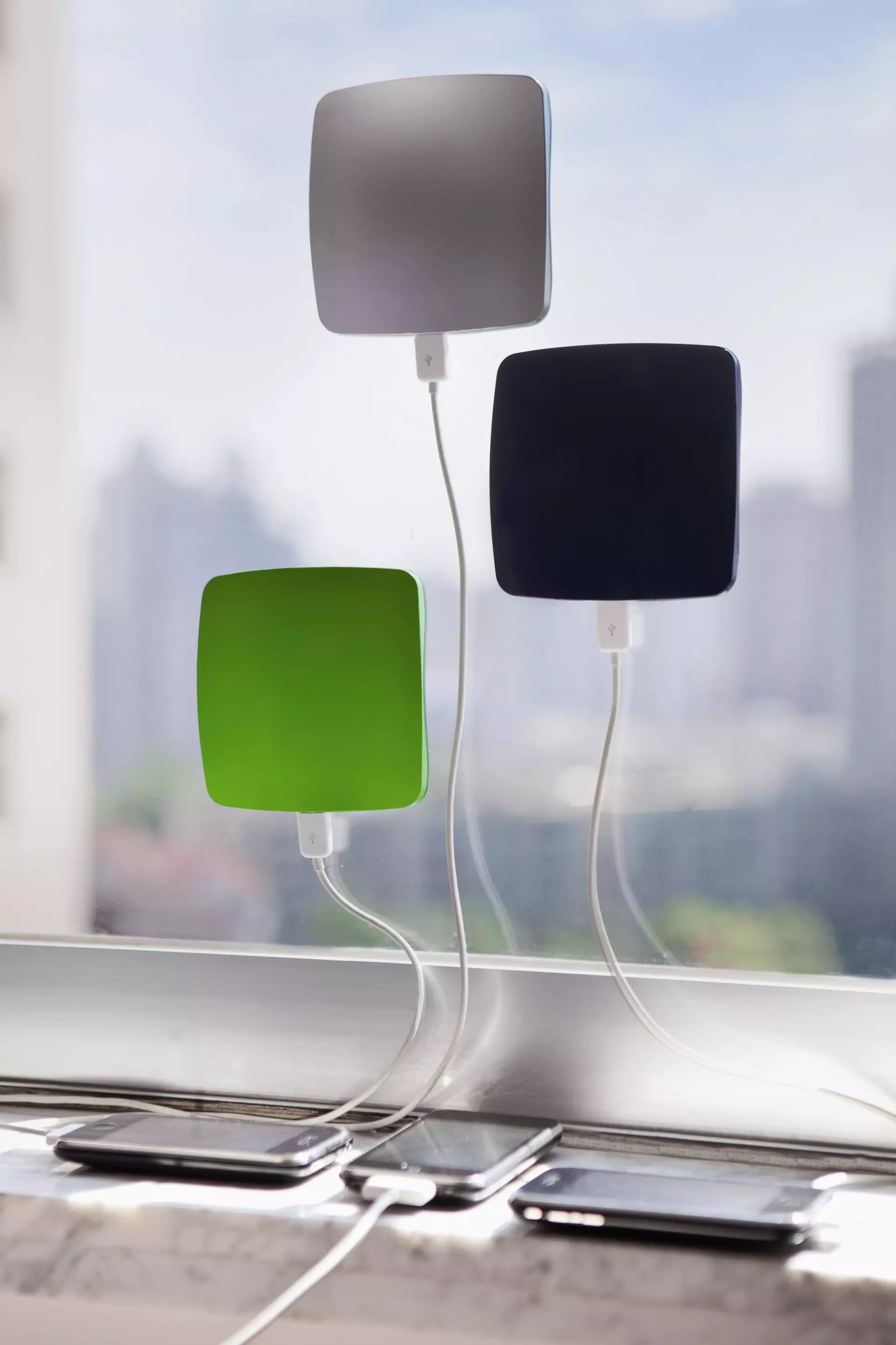 Users can stick the 0.68-inch thick Window solar charger to the inside of a glass window with the photovoltaic panels facing out, and then feed off a charging cable to a portable device positioned in the cooling shade