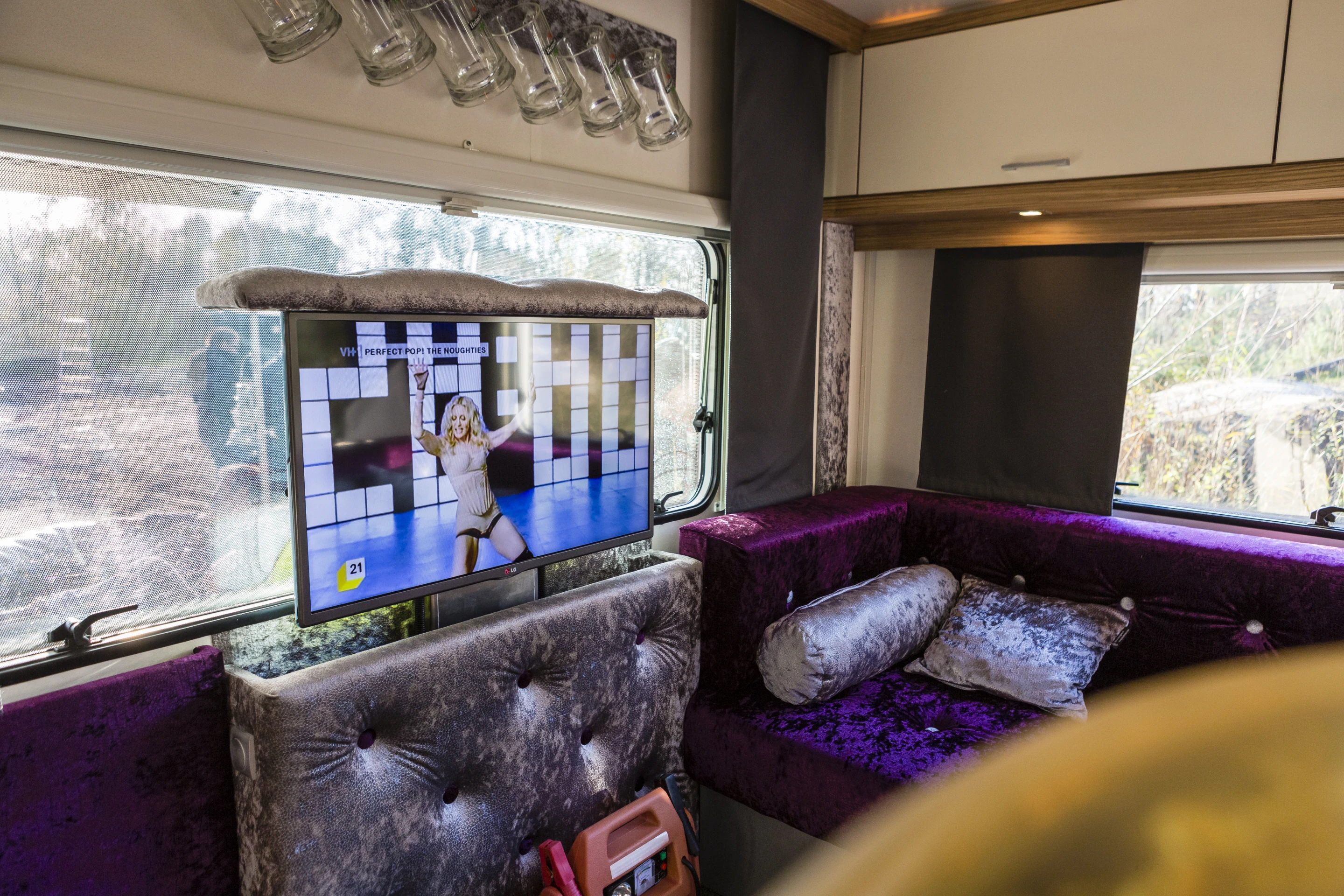 The TV retracts into the upholstered console