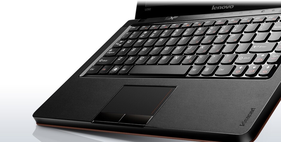 Surrounding the keyboard and touchpad is a faux leather palm rest