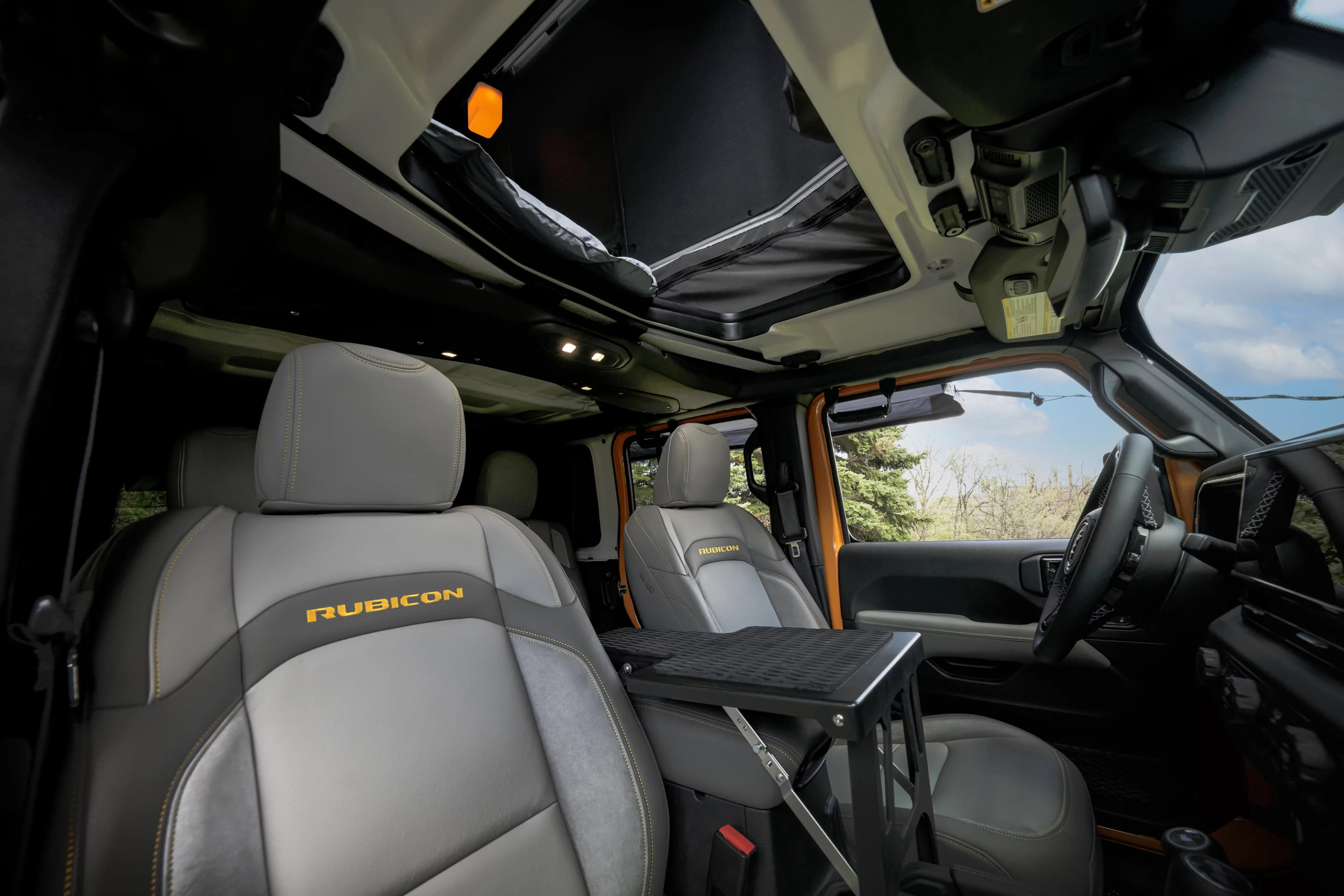 Jeep uses the Freedom Panel system to create tent access through the roof and adds in a central carbon fiber step