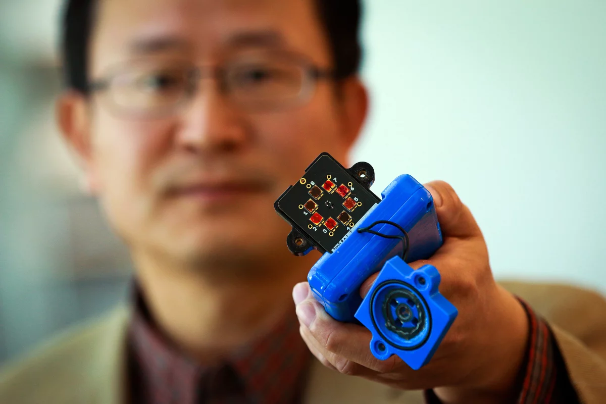 Ling Zang with his prototype explosives sensor (Photo: Dan Hixon, University of Utah College of Engineering)