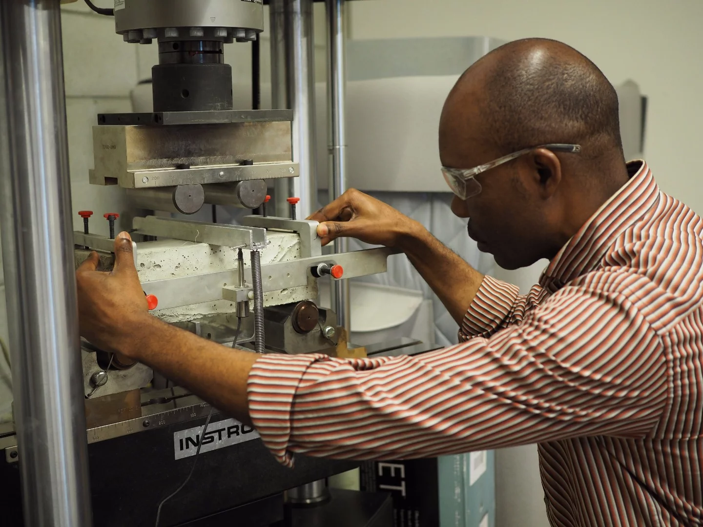 Civil engineering postdoctoral researcher Obinna Onuaguluchi tests the reinforced concrete