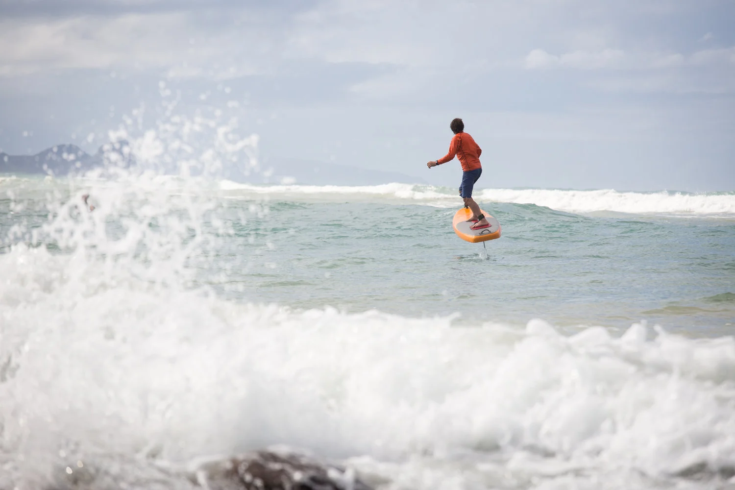 The electric-powered, remote-controlled Jetfoiler board rises above the waves