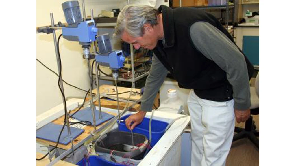 Bart Chadwick checks the condition in laboratory microbial fuel cells that may revolutionize naval energy use (Image: US Navy Photo by John F. Williams)