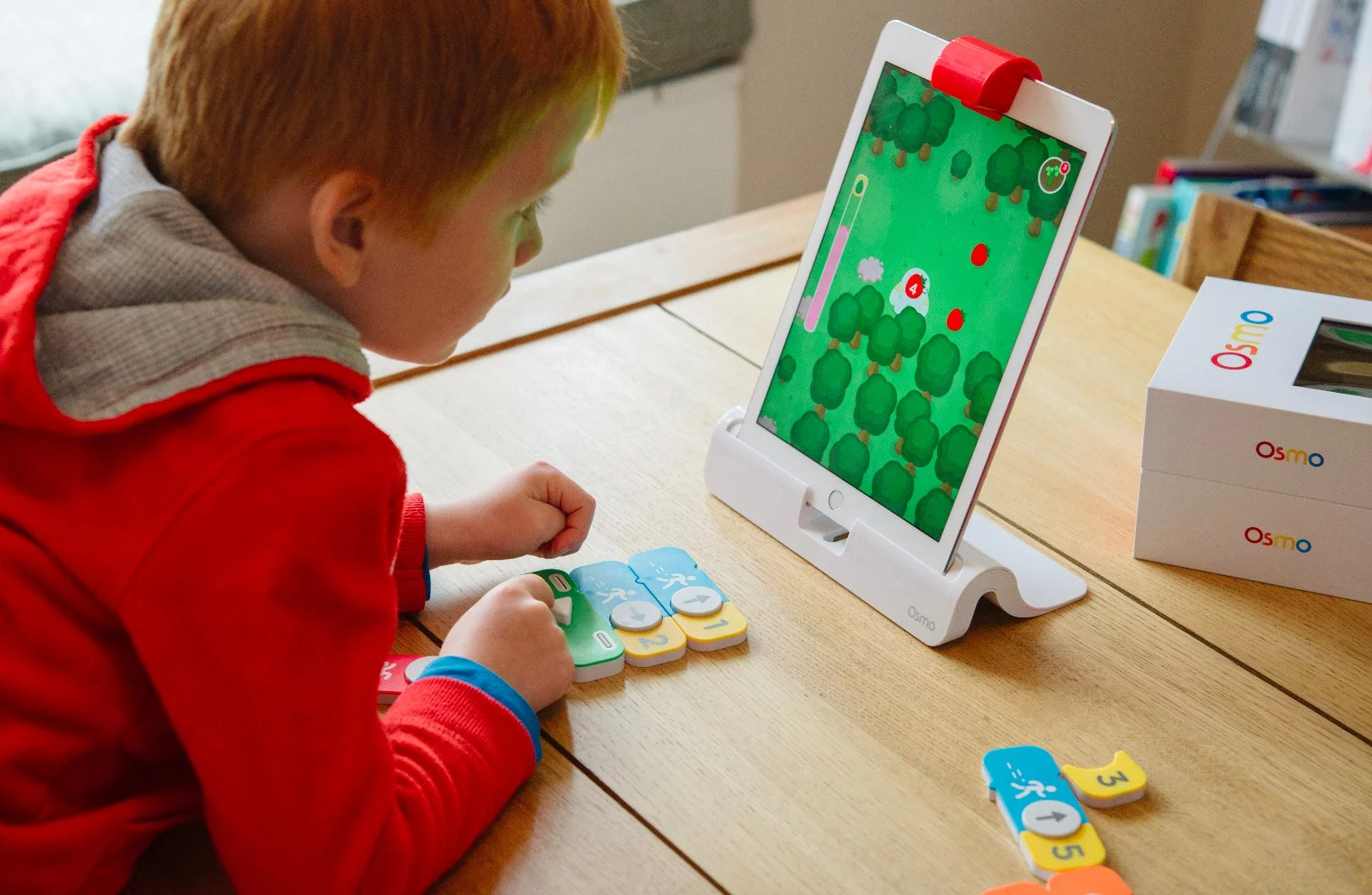 Osmo Coding teaches children about sequences and problem solving by sending a strawberry munching monster on a mission
