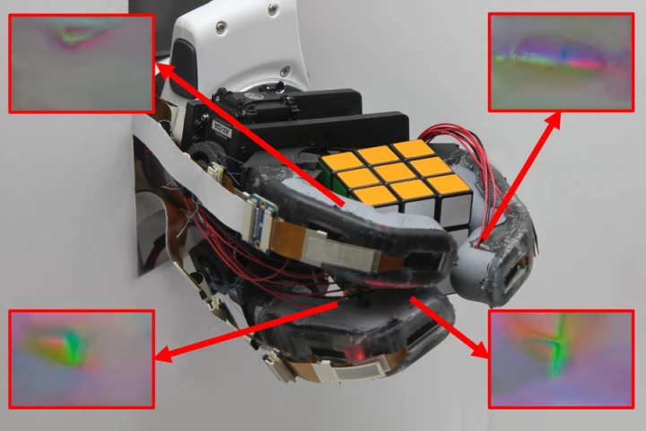 The GelSight EndoFlex hand grasps a Rubik's Cube, with insets showing how four of its six sensors see the contours of the object