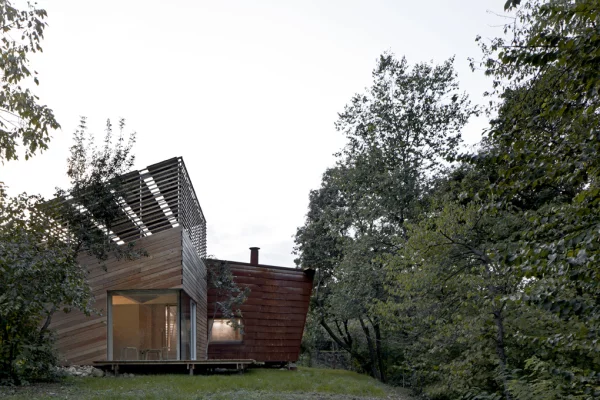 The home features two joining structures that are made from untreated larch wood and a Corten steel shell
