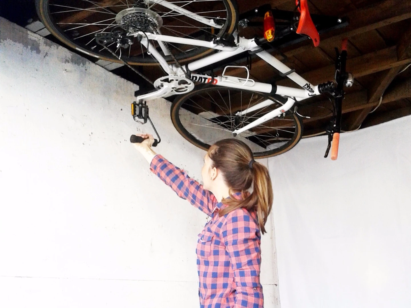 The Hide-A-Ride rack stores bikes parallel to the ceiling