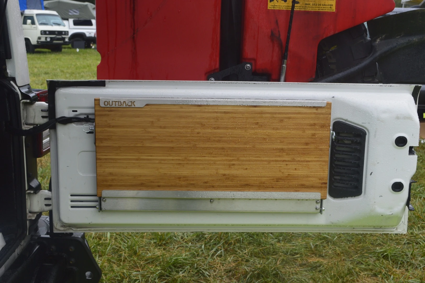 A bamboo cutting board on the tailgate