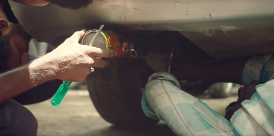 A cylindrical filtration device known as the KAALINK is retrofitted to a car's tailpipe, where it collects a claimed 95 percent of particulates from the exhaust