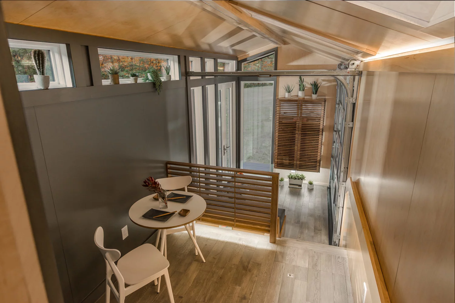 The Orchid Tiny House's raised area includes a dining room and kitchen
