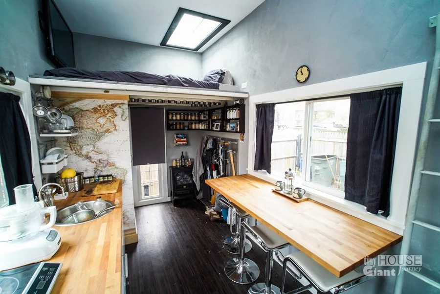 The matchbox has two workspaces, as well as a raised sleeping area (Photo: Tiny House Giant Journey)