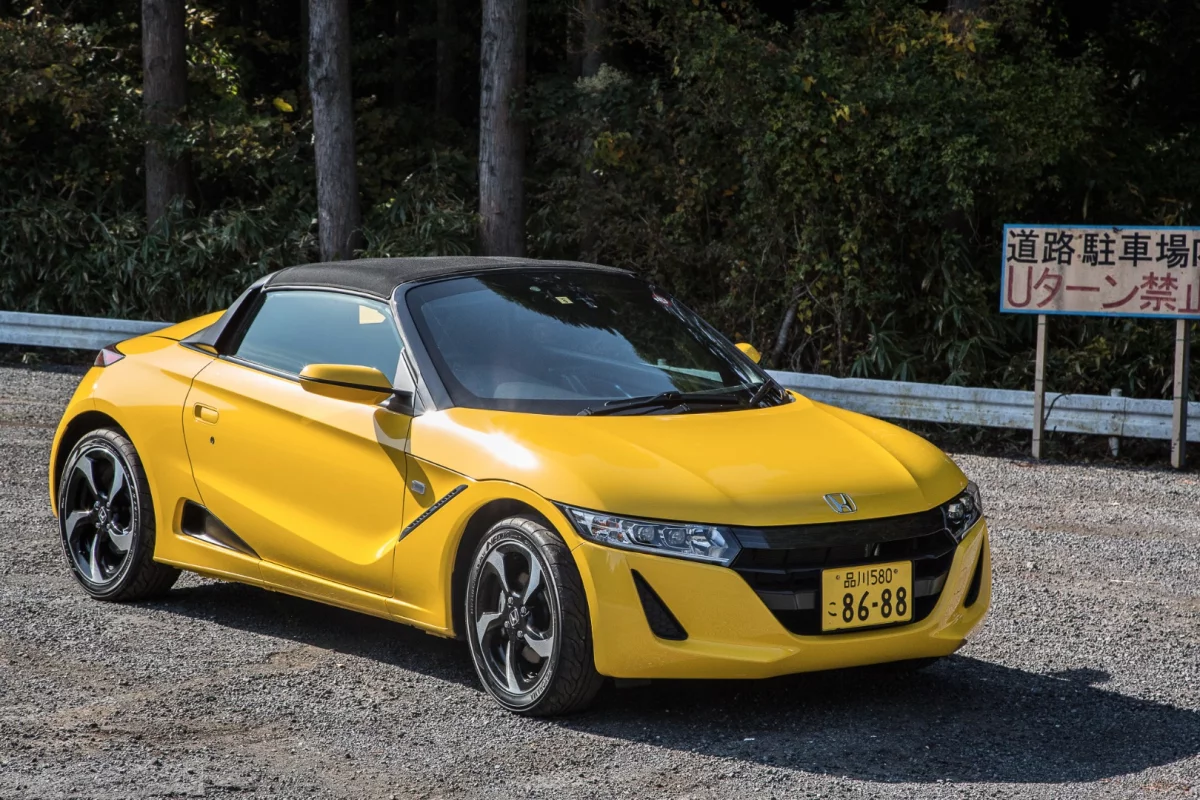 The car's canvas roof can be taken off and stored in a small compartment under the bonnet