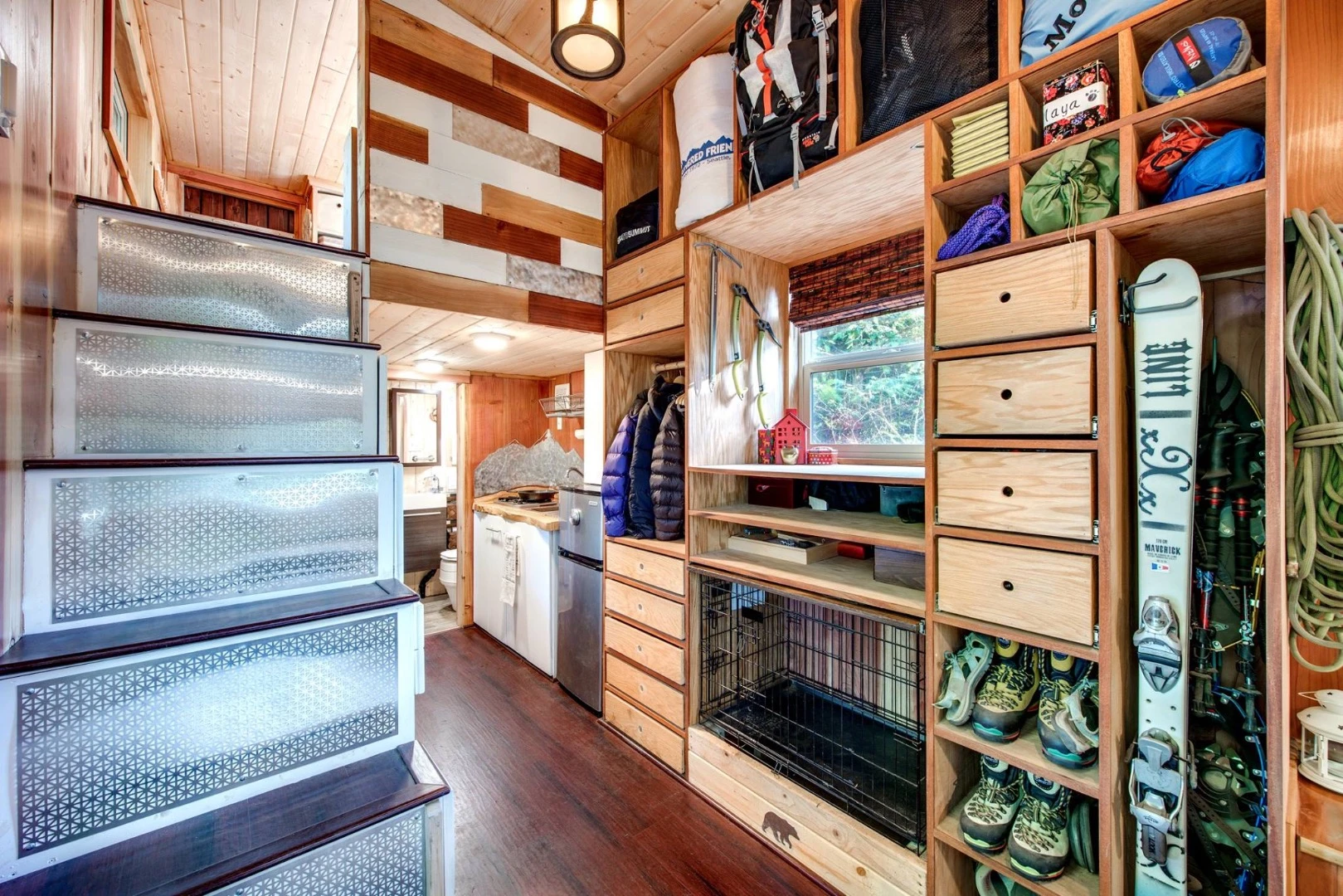 A storage-integrated staircase leads upstairs