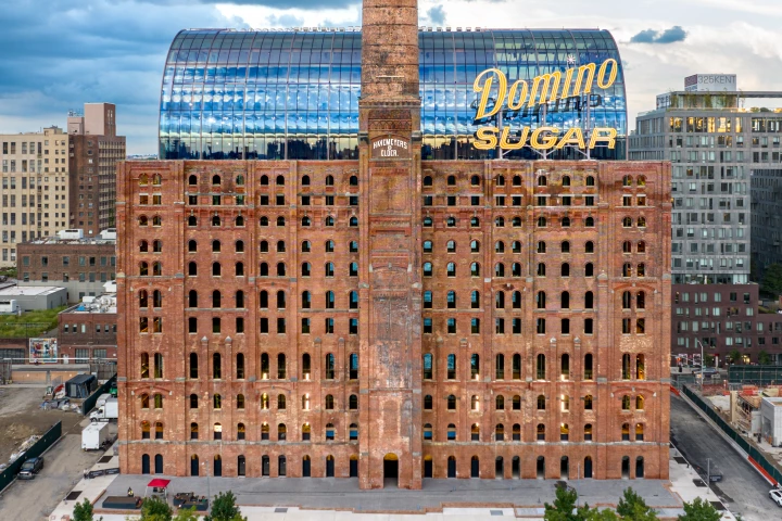 The Refinery at Domino inserts a modern glass office into an industrial building that was originally completed in 1884