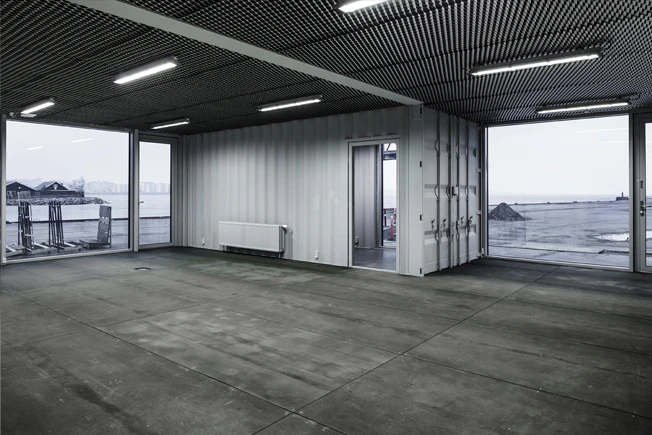 Made to be Moved features used shipping containers – complete with dents – that have been painted grey to produce a uniform look