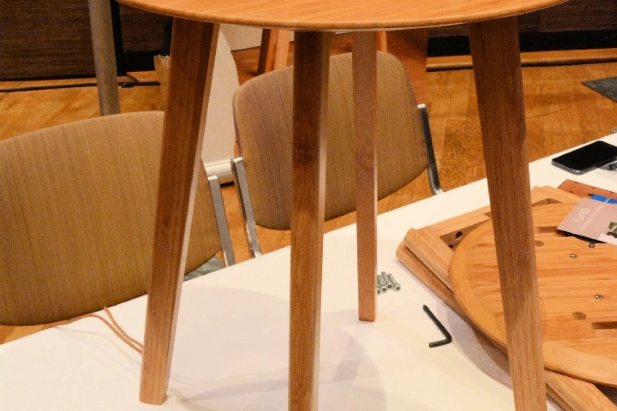 A fully-assembled FurniQi side table with Qi-compatible devices on top