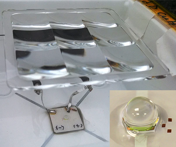 Dual-stage optics, consisting of a molded 2 X 2 cm primary lens and a secondary, 2 mm ball lens (inset) focus incident sunlight by more than one thousand times