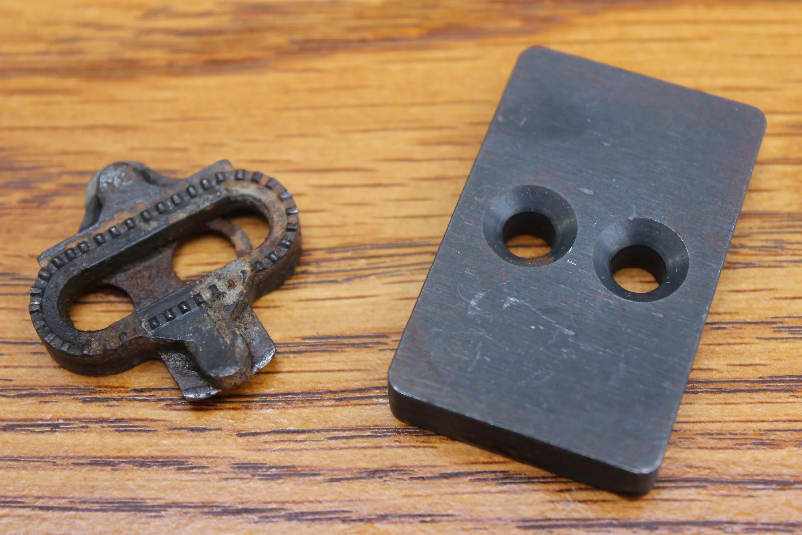 A Shimano SPD cleat (left) as compared to a MagLOCK cleat