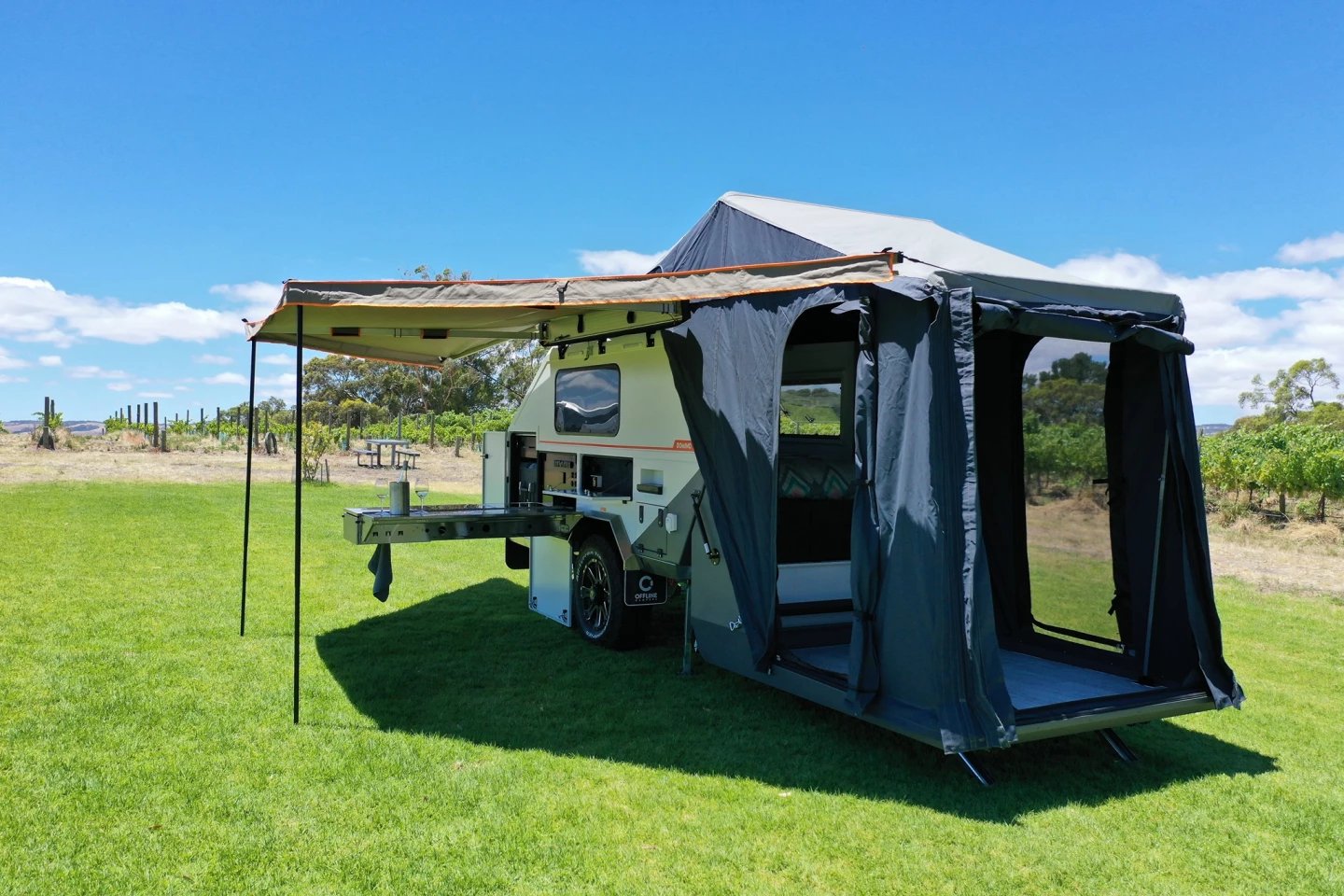When fully set up, the Offline Domino includes a shaded outdoor kitchen, changing room tent and cozy hard-sided sleeping cabin