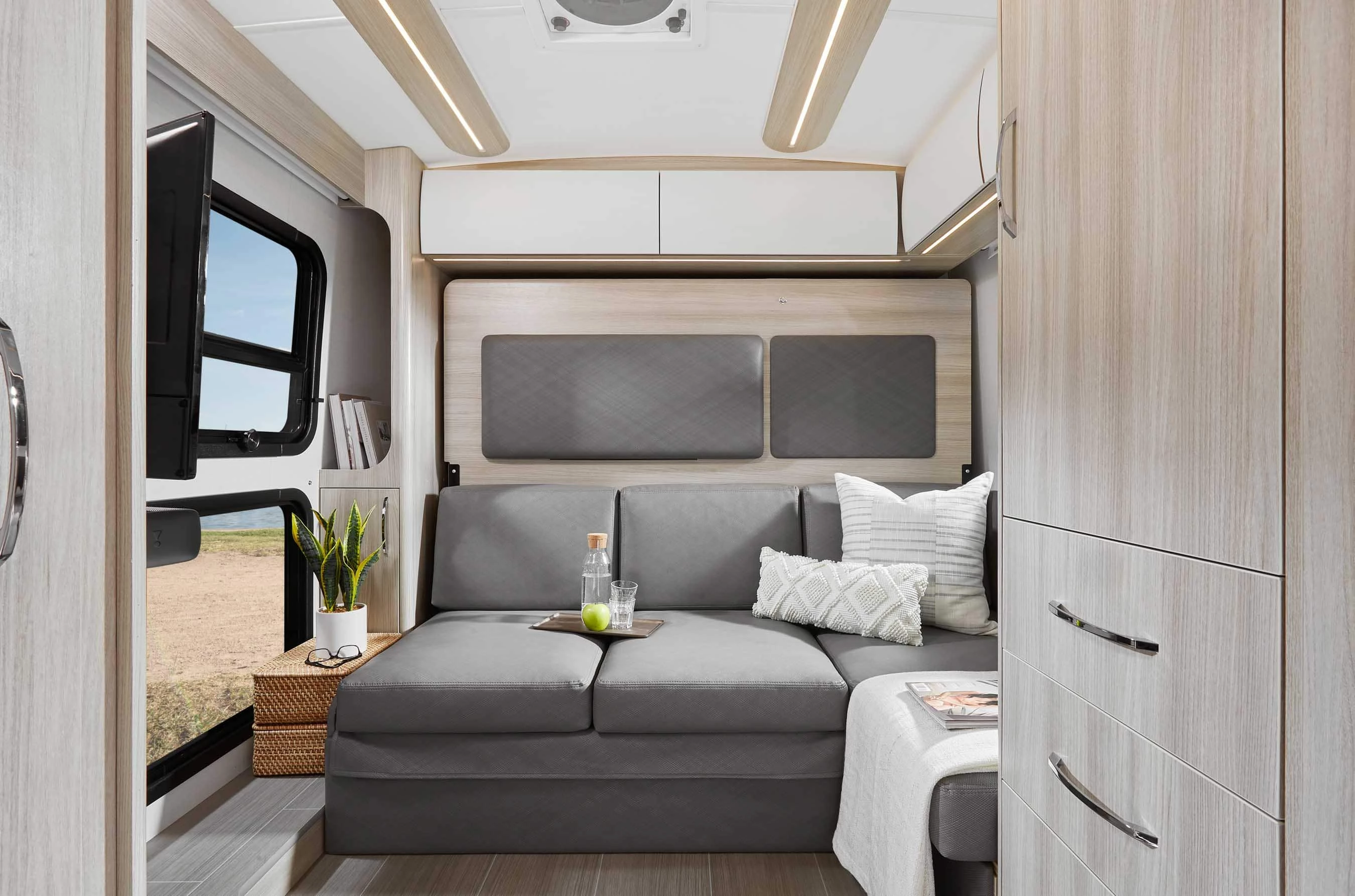 The sofa offers views of the television and large picture window array