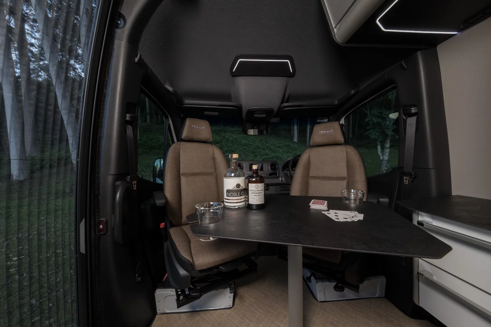 Swivel cab seats and a removable dining table provide dining space for the van's two occupants