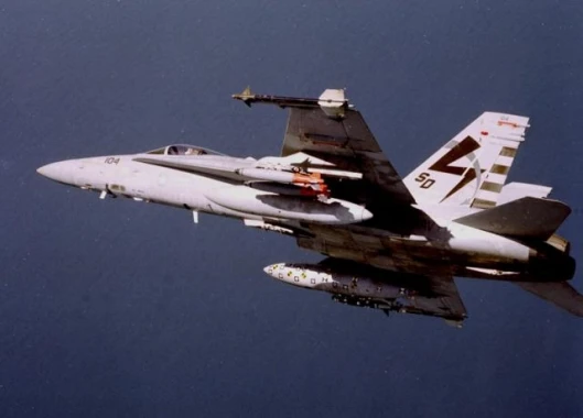An F/A-18 fitted with a BRU-55 dual-carriage, "smart" bomb rack