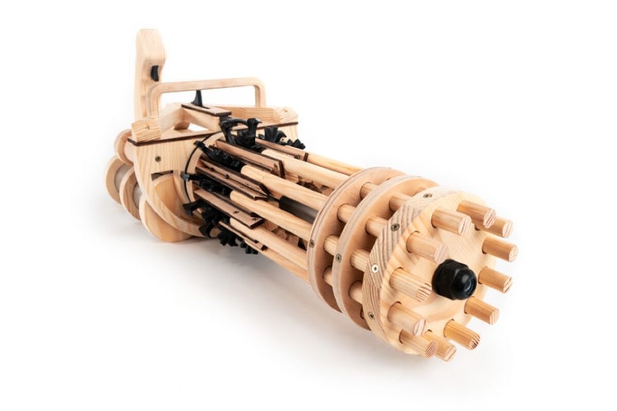 The Rubber Band Minigun is available as a fully assembled toy weapon, or as a DIY kit that arrives with 70 separate pieces