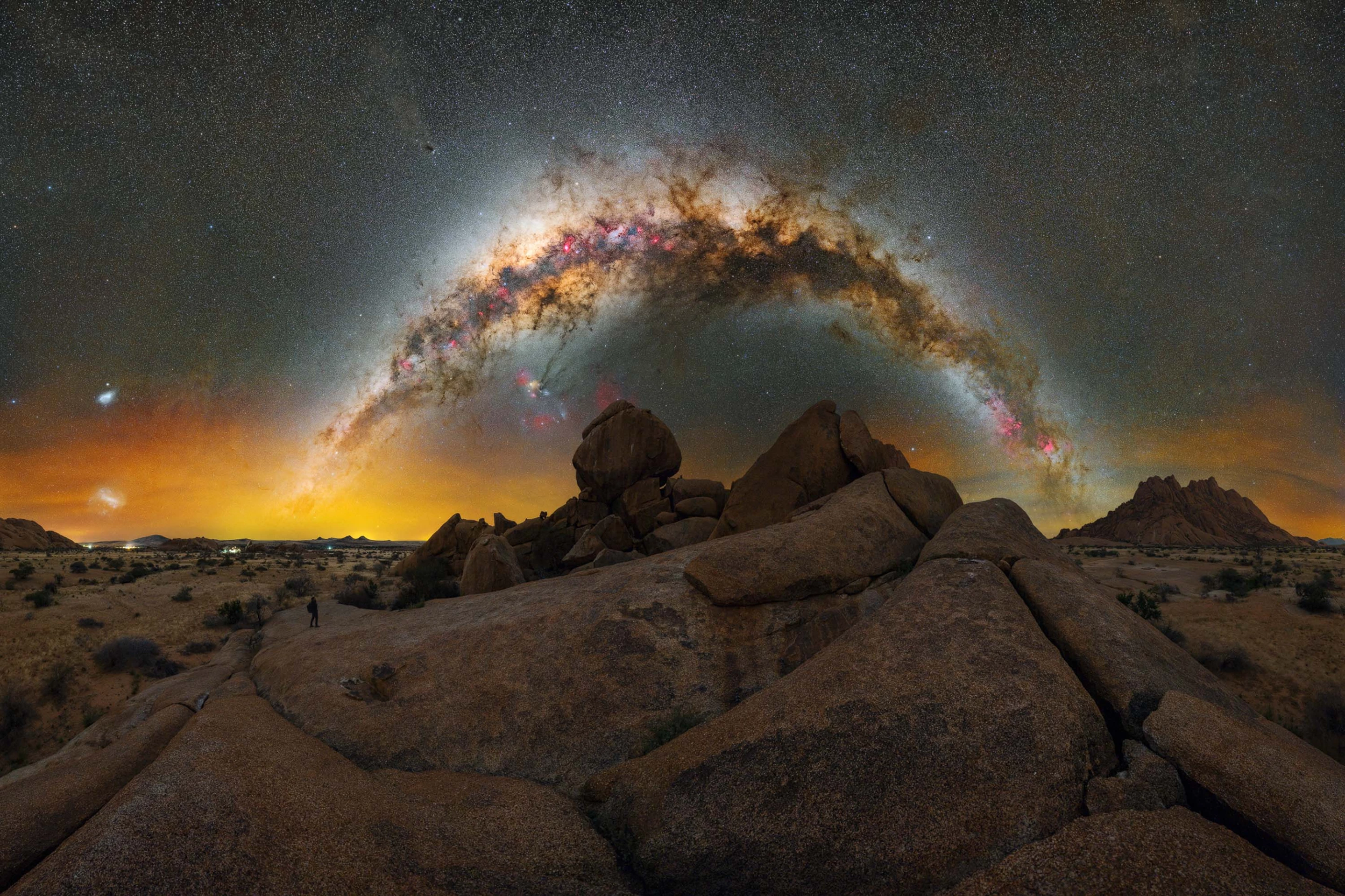 South of Home by Lorenzo Ranieri Tenti, snapped in Namibia, Africa. This formation of smooth granite boulders in the Gross Spitzkoppe Nature Reserve perfectly accentuates the arch of the Milky Way, tinged with a golden glow