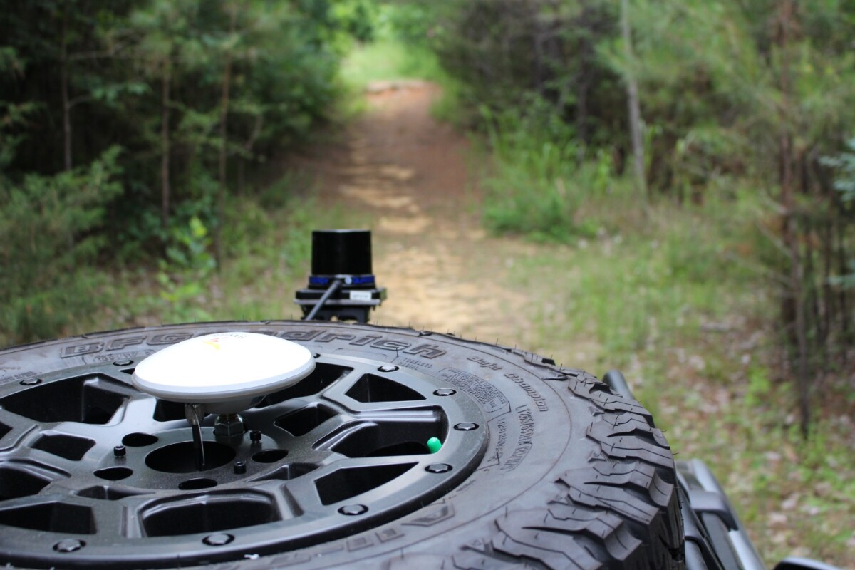A GPS antenna and LiDAR sensor are visible on a data collection run on MSU's off-road track