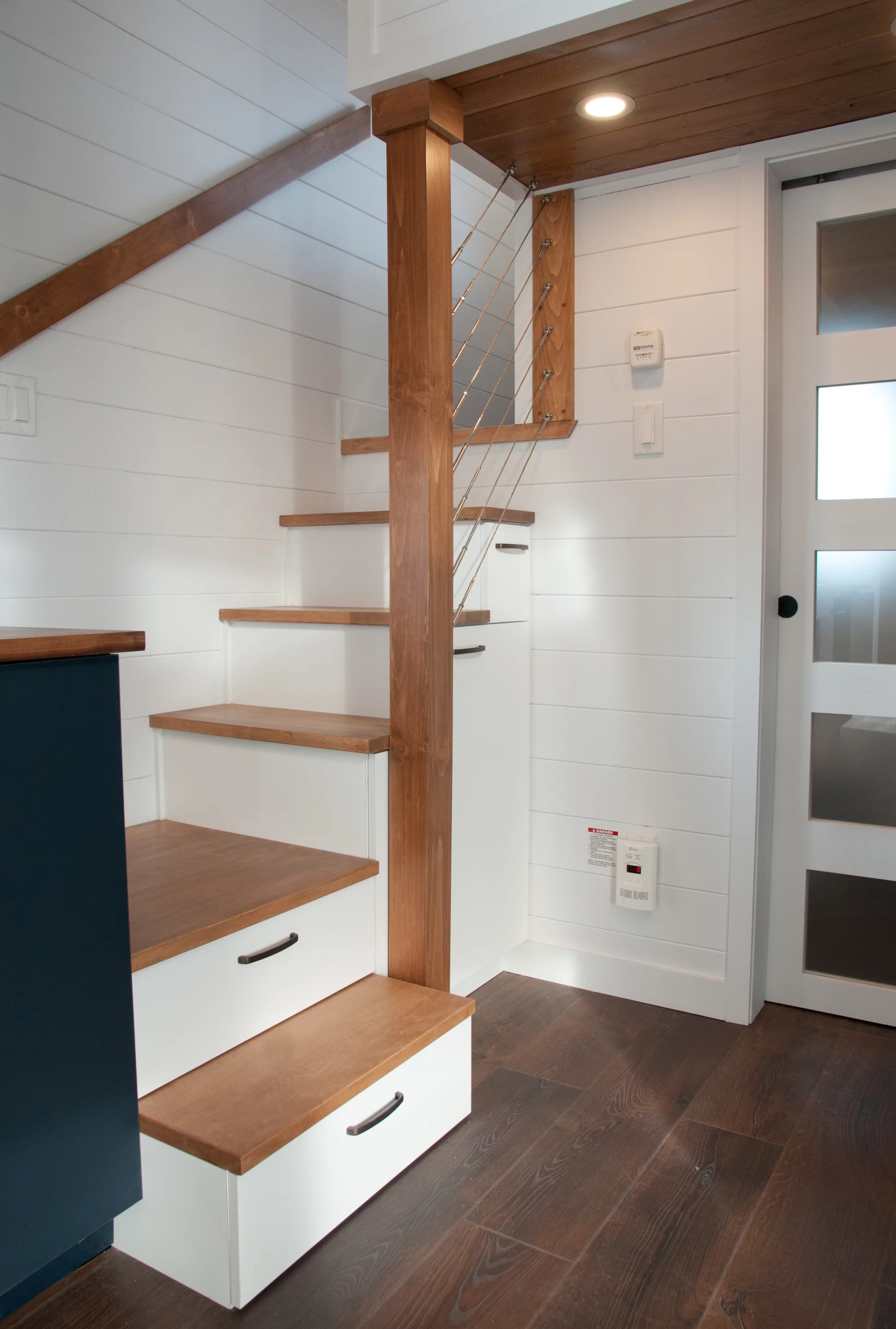 The Charme V2's main loft bedroom is reached by storage-integrated staircase