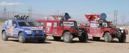 The first three vehicles to finish, with the winner expected to be the Stanford team at left, followed by the two Carnegie Mellon vehicles, H1ghlander and Sandstorm