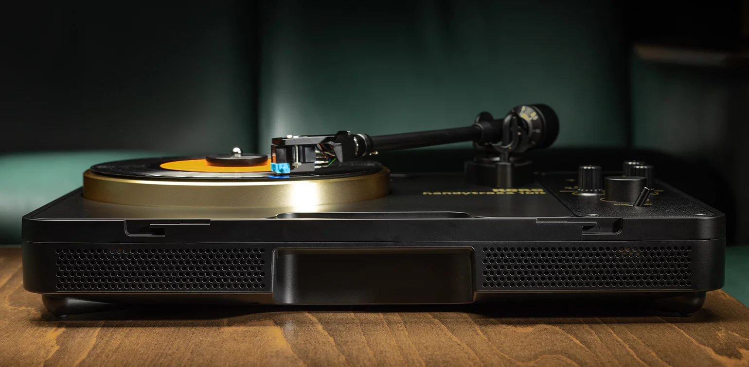 The Handytraxx 1bit portable turntable can run on batteries, has built-in speakers, and features a belt-driven aluminum platter, tone controls and a JICO MM cartridge