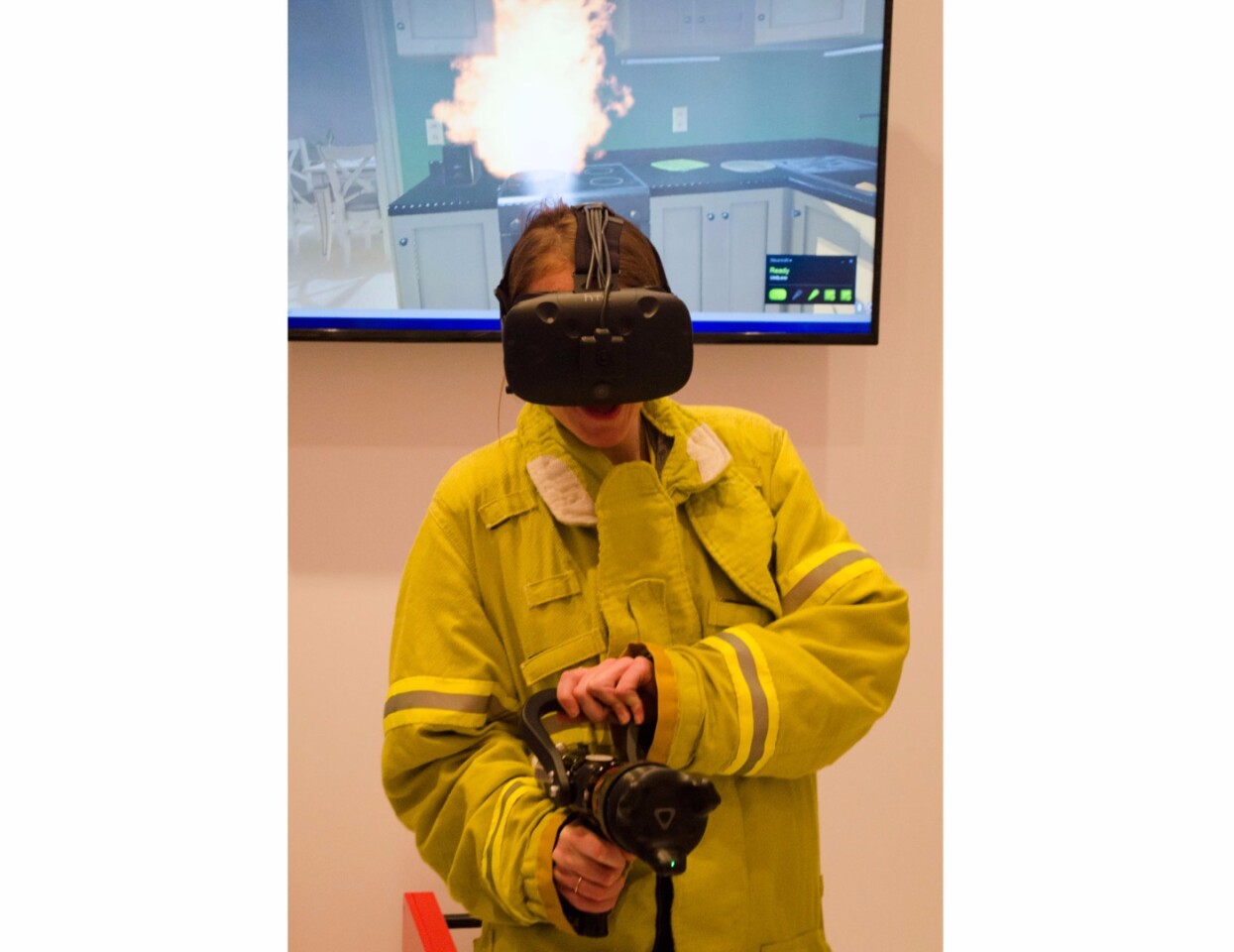 Fighting fires in VR with the help of a ViveTracker-equipped fire hose and a heated coat that mimics the heat of fire exposure